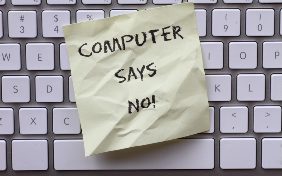 An image that shows a computer keyboard with a post it note that says the words - computer says no. 